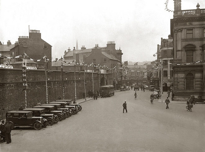 Guildhall Place circa 1932 with old city walls and Northern Counties Hotel just visible behind front building.